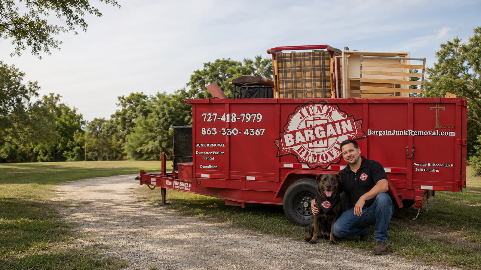 Nick, owner of Bargain Junk Removal, with his dog beside the company's red dump trailer